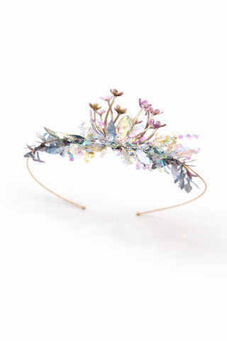 Decorative headband with flowers and beads on a white background