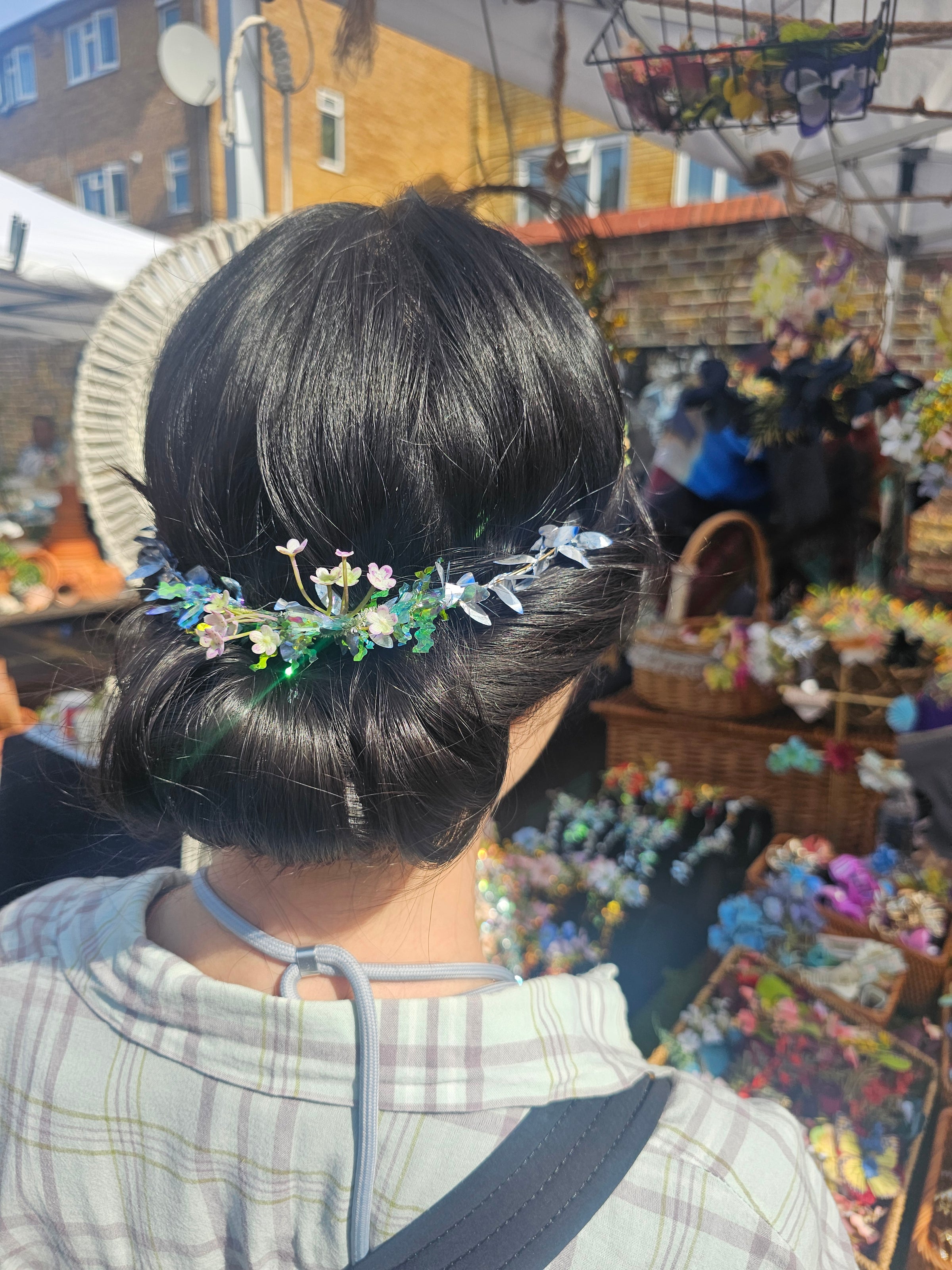 Close-up of a person with styled hair in an urban setting