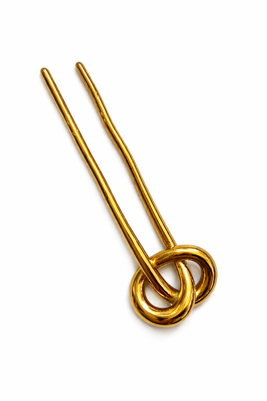 Gold hairpin with two circular loops on a white background
