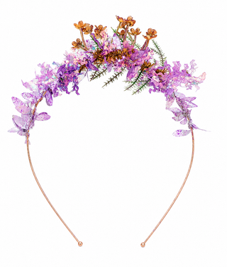 Purple floral Alice band with delicate blossoms, purple foliage, green accents and gold-tone detailing for weddings and special events.