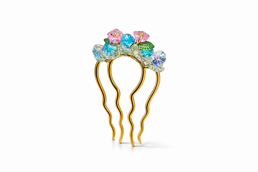 Decorative hairpin with colorful gemstones on a white background