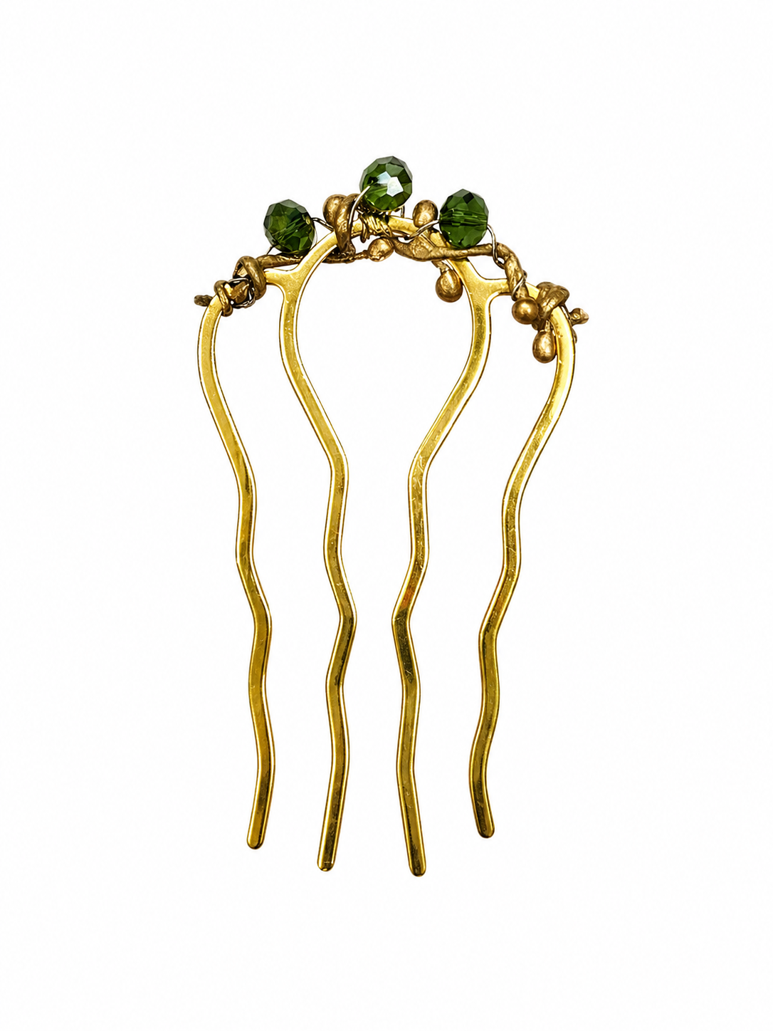 Gold hair comb with green stones on a white background