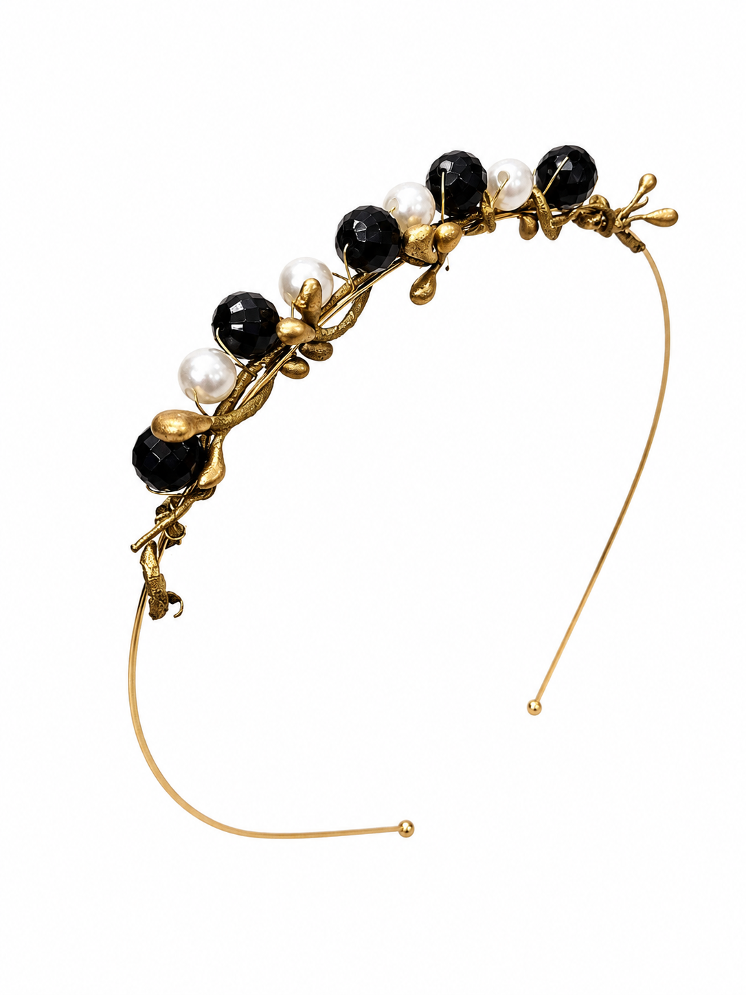 Gold headband with black and white beads on a white background