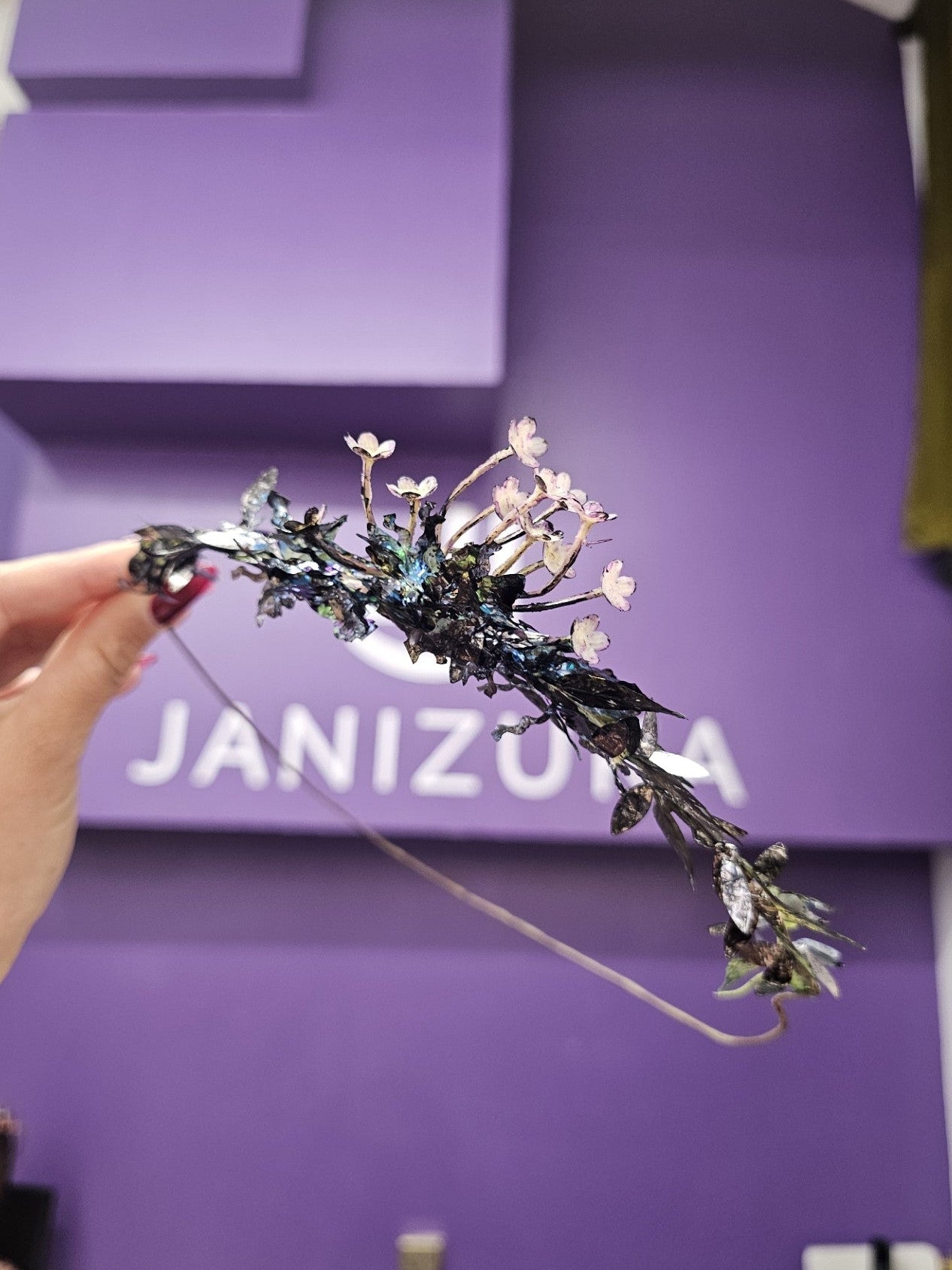 Black floral crown halo headpiece, worn to lift hair and add height with janizuka logo