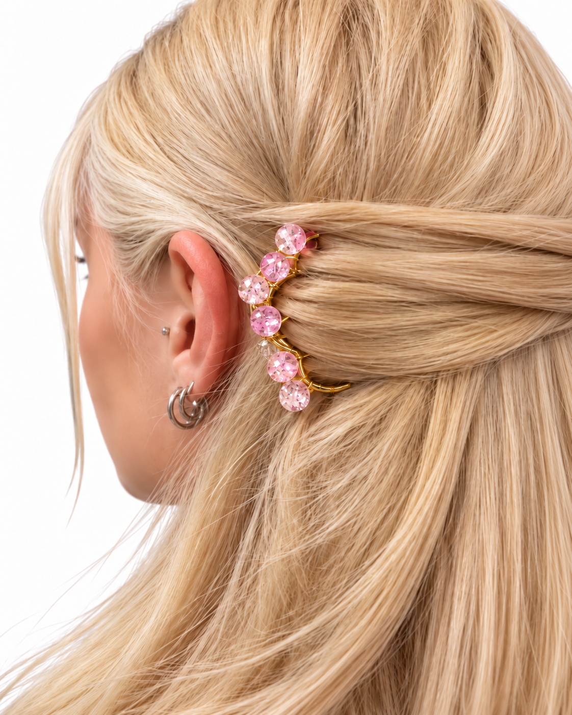 Handmade pink crystal brass hair comb styled in blonde hair for an elegant bridal or special occasion hairstyle.