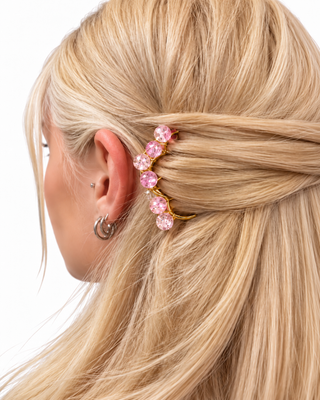 Handmade pink crystal brass hair comb styled in blonde hair for an elegant bridal or special occasion hairstyle.